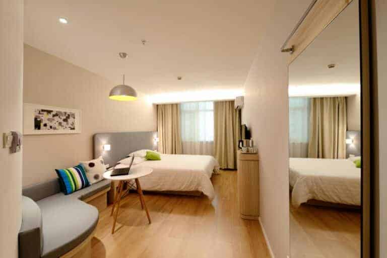 Comfortable hotel bedroom with modern furniture and cozy decor.